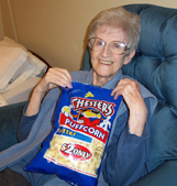 Mum on her birthday with her favorite Puffcorn snacks (08/07/15). Click on image to view larger size in a new window.